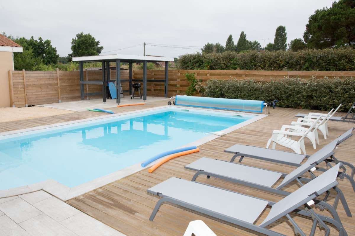 Modern house beside a beautiful swimming pool, reflecting pool chemical regulation topic