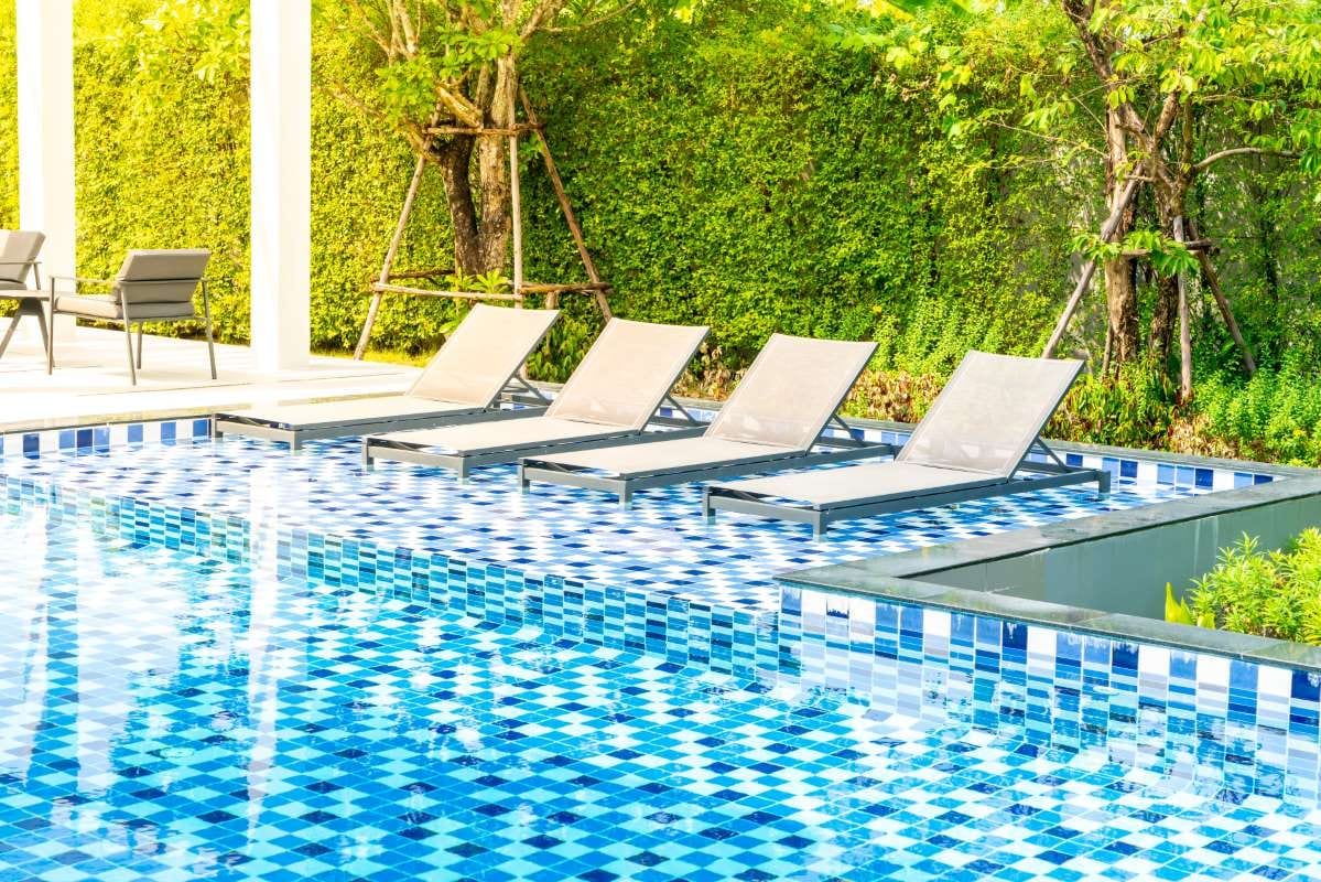 Hotel resort poolside bed near an outdoor swimming pool