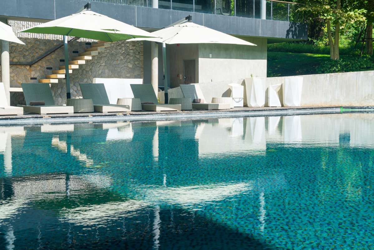 Umbrella-shaded poolside bed suggesting a relaxed vacation setting