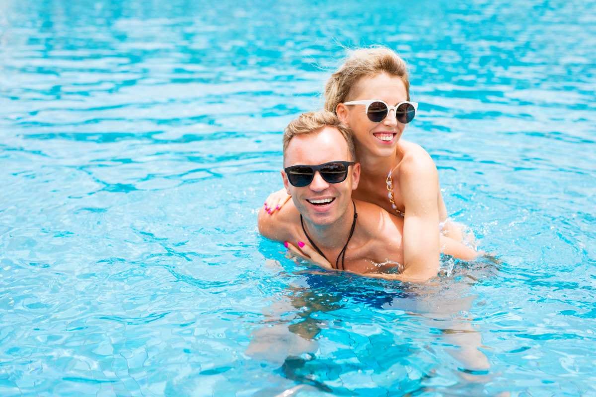 Couple having fun in a pool, illustrating engaging skill training through video tutorials