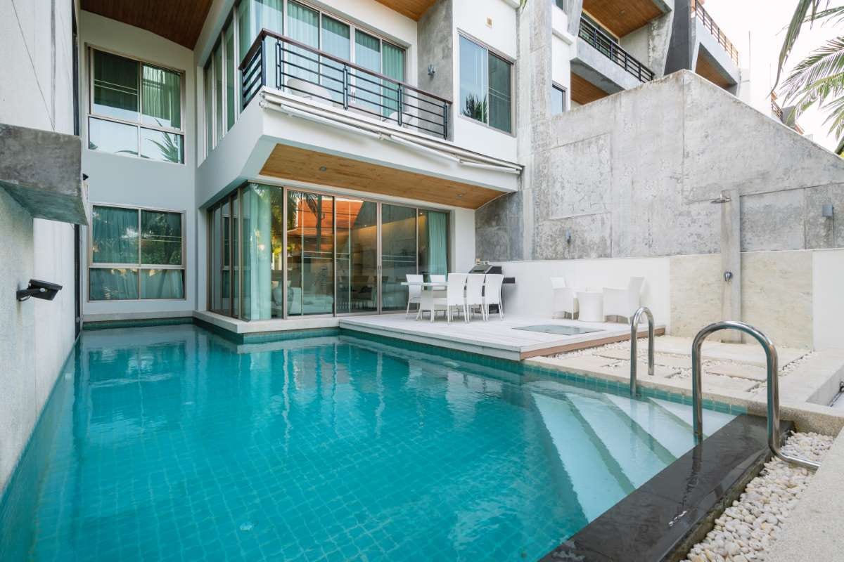 Modern pool villa exterior with an outdoor swimming pool and house facade
