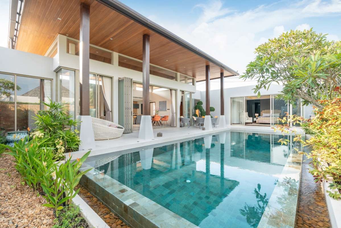 Tropical pool villa exterior with lush garden greenery