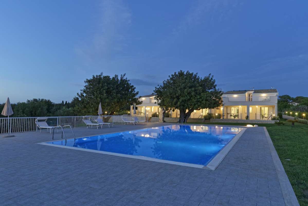 Sicily countryside house with garden and swimming pool at sunset