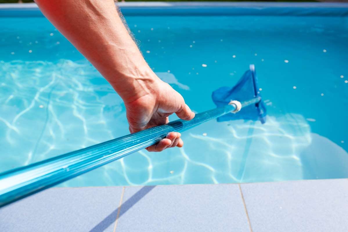 Male hand holding a pool net cleaner