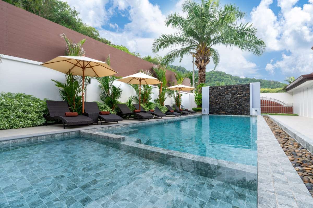 Outdoor swimming pool beside a terrace, evoking technician time management coaching