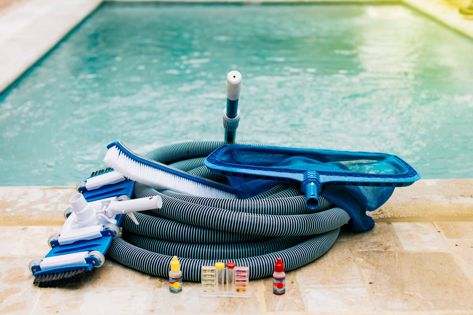 Pool cleaning maintenance kit with vacuum, pH test kit, leaf picker, and pool sweeper