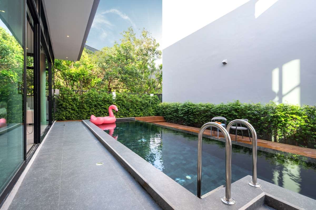 Pink floating duck in an infinity pool beside a terrace