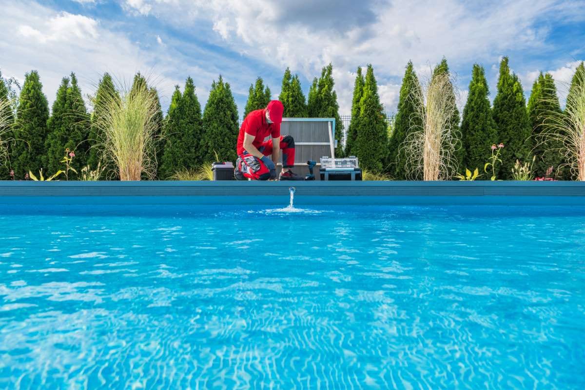 Professional swimming pools technician performing seasonal maintenance