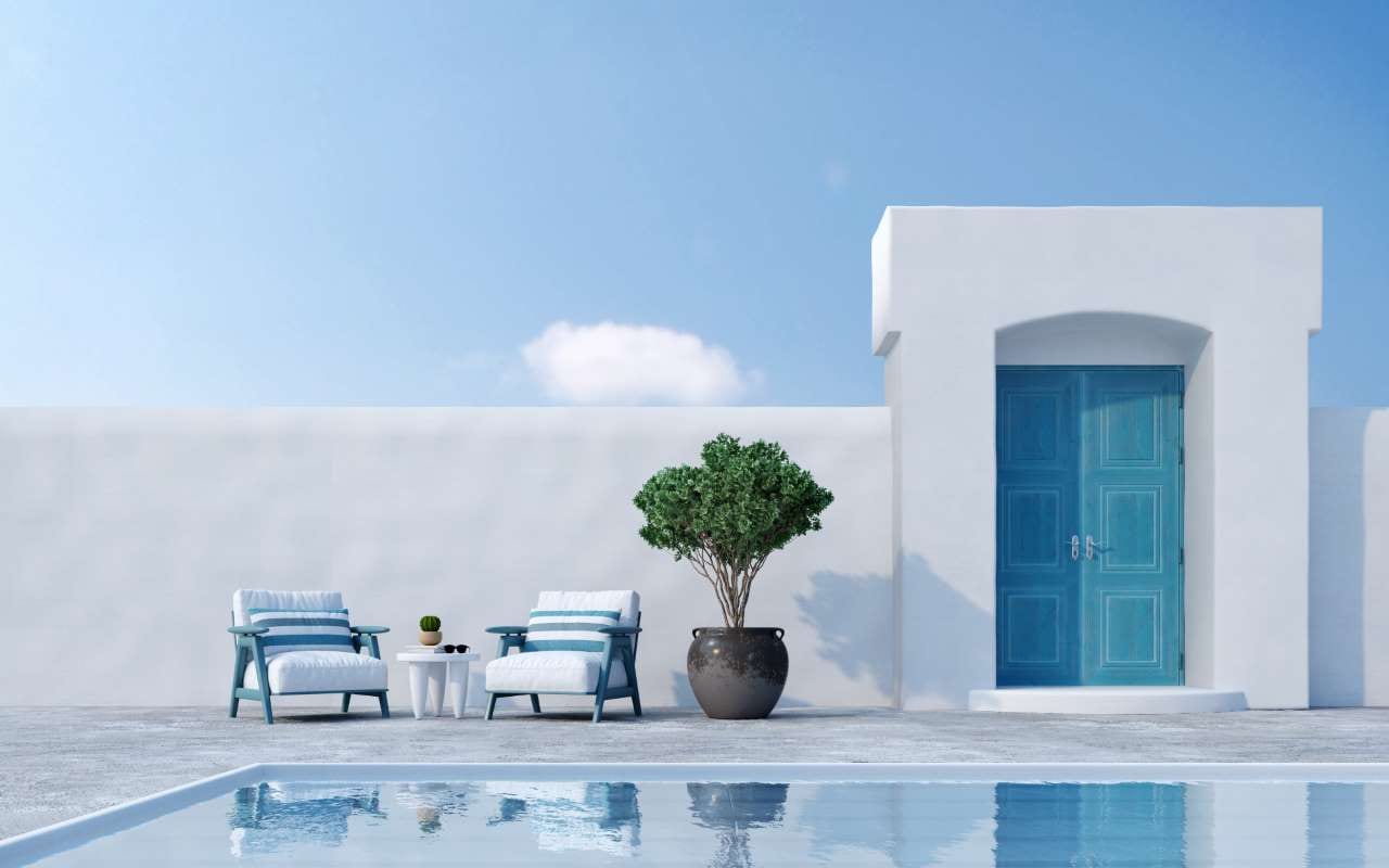 Santorini-style patio with armchairs, plant, door, and swimming pool in a 3D rendering