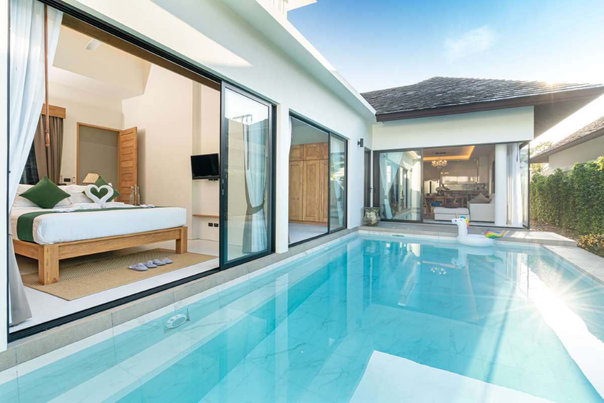Luxury villa pool with clear blue water and sunlit deck