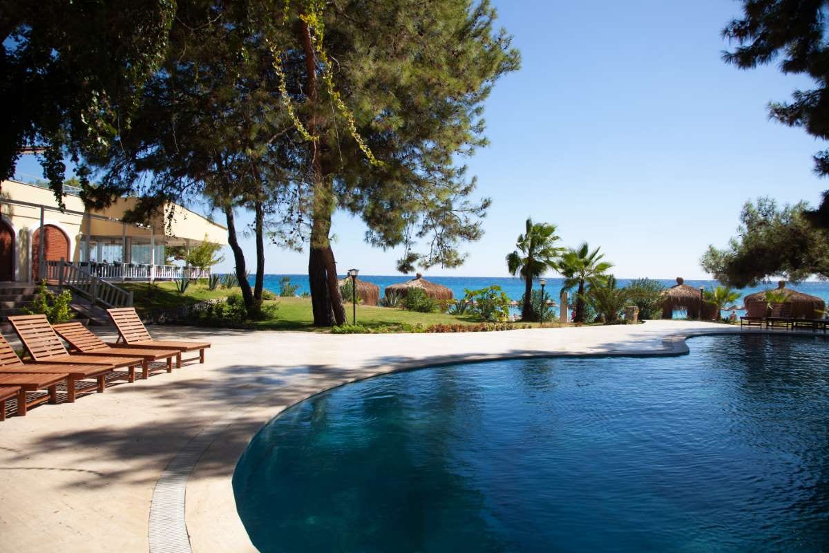 Swimming pool resort near the sea with calm water and lounge area