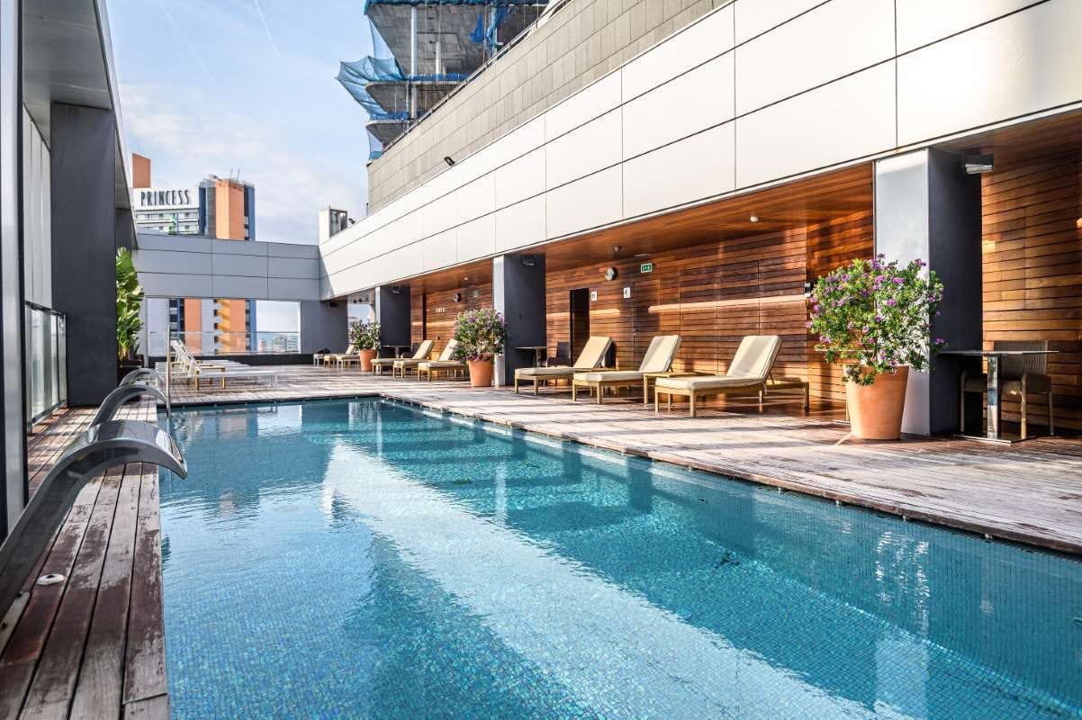 Rooftop swimming pool with city skyscrapers and Barcelona skyline view