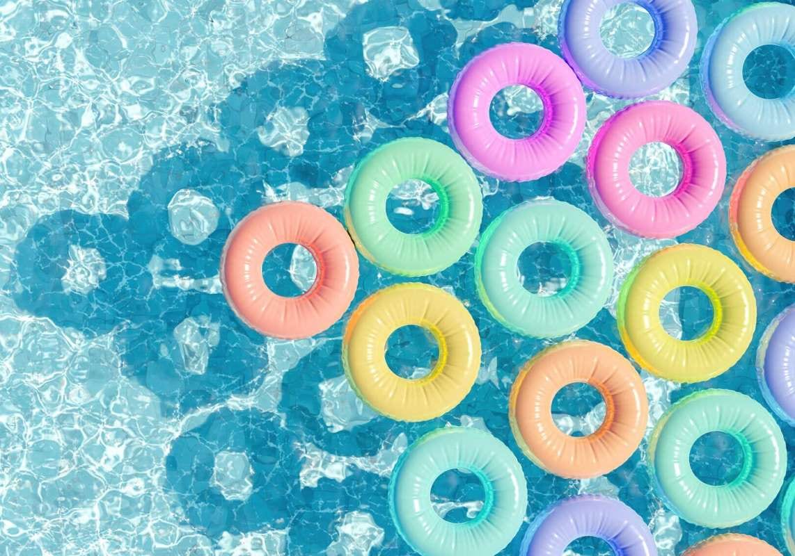 Pastel floating rings in a swimming pool seen from above