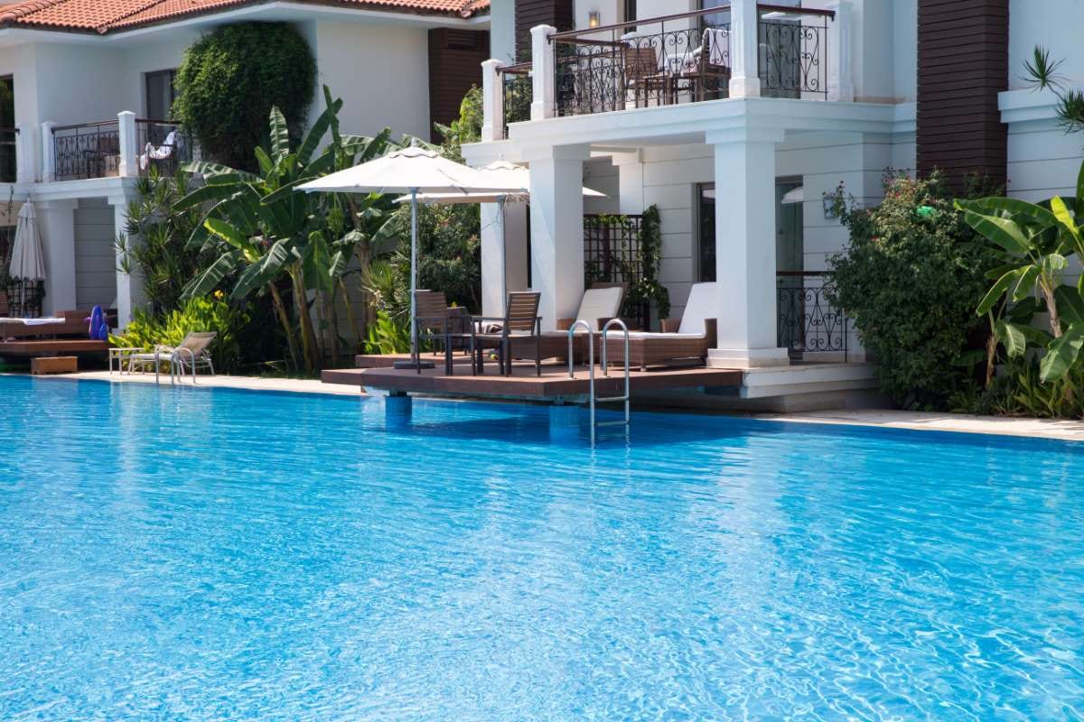 Resort swimming pool with poolside loungers and summer vacation feel