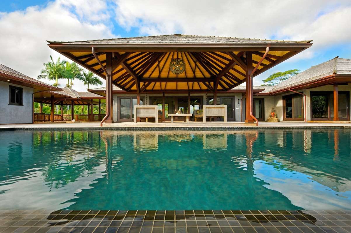 Swimming pool with a house in the background
