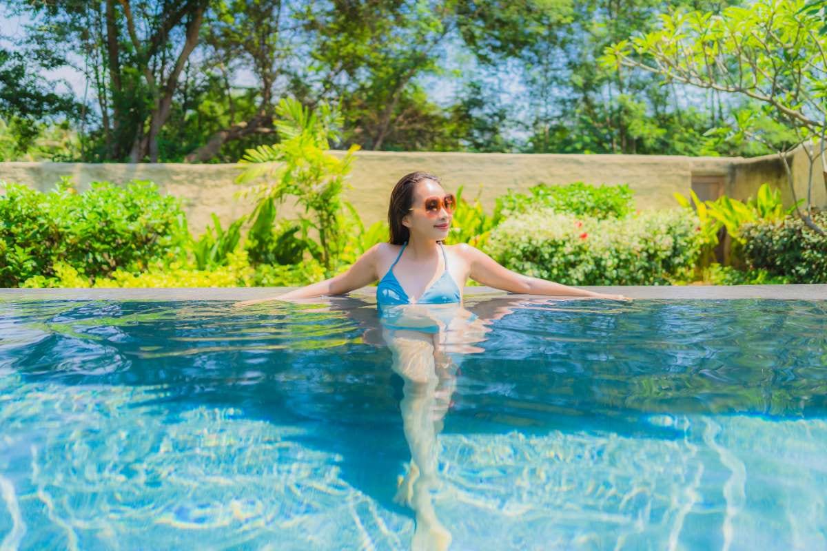Woman swimming in a pool, matching a pool service invoicing guide